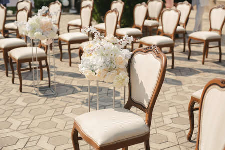 Beautiful wedding floral arrangement of seats along the aisle.の写真素材