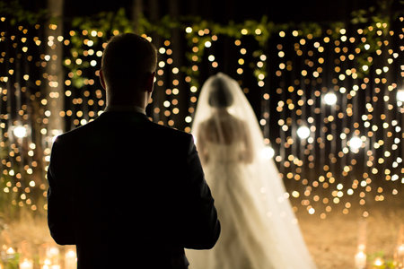 Wedding ceremony night. Meeting of the newlyweds, the bride and groom in the coniferous pine forest of candles and light bulbsの写真素材