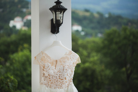 wedding dress hanging on a balcony on a background of snow-capped mountains.の写真素材