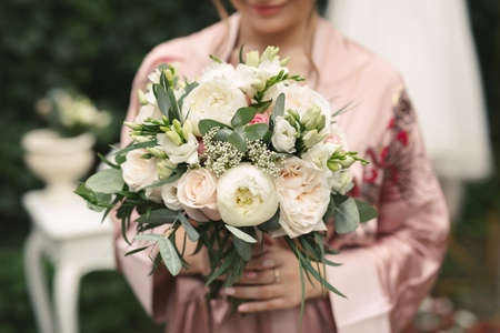 Close-up of a bouquet of flowers in the hands of the brideの写真素材