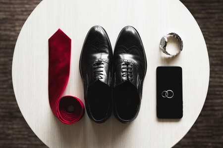 Groom is gathering in the morning.Mens classic shoes, belt,toilette, perfume, leather strap watch,...