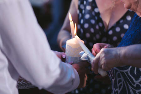 Wedding ceremony, paraphernalia, the bride and groom hold a large candle in their hand.の写真素材