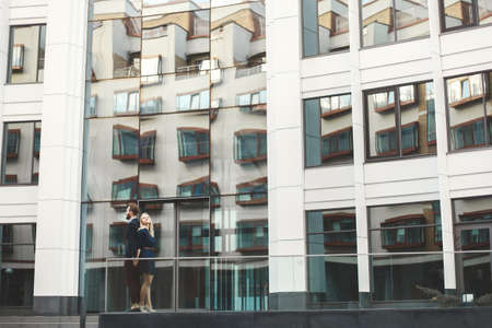 Love Story. Happy couple man and woman. High, white building