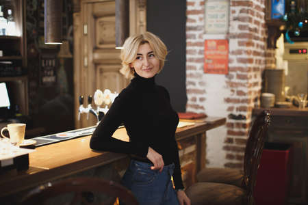 Beautiful woman posing on the bar counter.