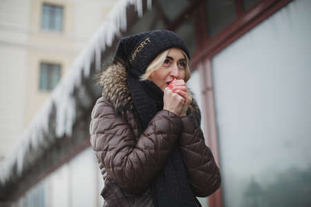 portrait of beautiful happy smiling woman posing outdoors in winter