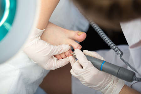 Professional pedicure master making pedicure in salon.の写真素材