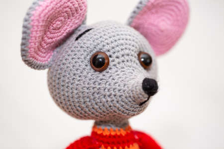 A knitted mouse. A soft toy as a symbol of the New Yearの写真素材