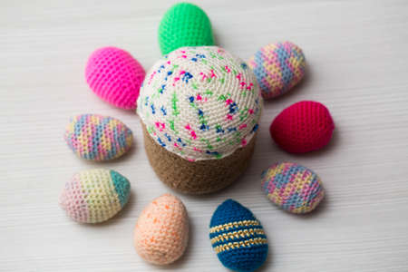 Knitted Easter eggs, chicken, cock on a white table.の写真素材