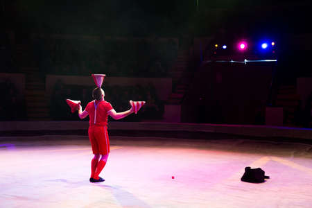 Acrobat performs a difficult trick in the circusの写真素材