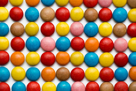 Close up of a pile of colorful chocolate coated candy, chocolate pattern, chocolate background.