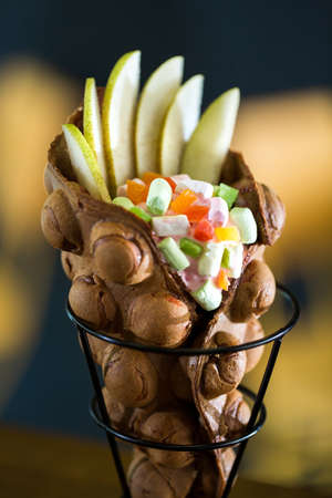 Hong Kong style egg waffle with pear and candy.の写真素材