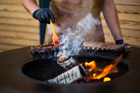 Grilled pork baby ribs with barbecue sauce on the grill. Festival street food.の写真素材