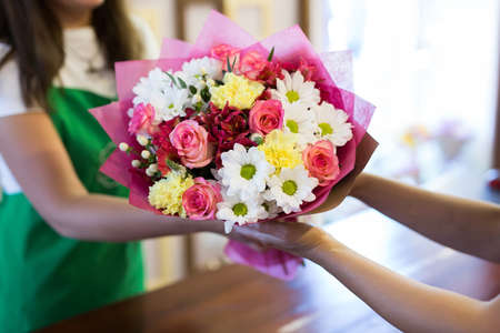 florist will give the client a beautiful flower bouquet.の写真素材