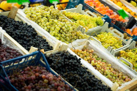 Some red and green grapes for sale at the supermarket.の写真素材