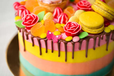 Colourful cake for a kids birthday party with Lollipop, candy, marmalade, cupcakes and Bunny.の写真素材