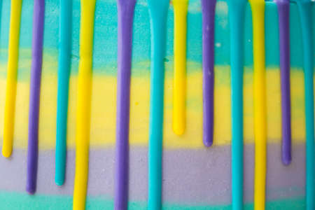 Chocolate drops on a striped cake close-upの写真素材