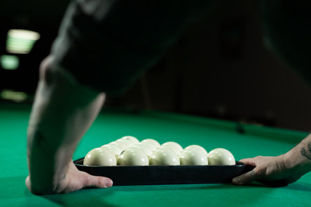 Placing balls at the billiard table with triangle.の写真素材
