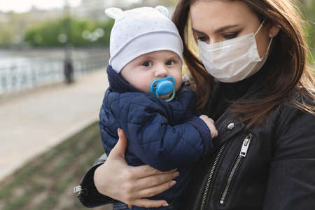 Beautiful woman and her son wear protection mask for corona virus or covid-19 virus outbreak and pm 2.5 in a city.の写真素材