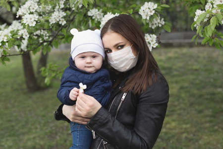 Portrait of a woman and her son in a protective mask against the crown virus or an outbreak of the covid-19 and pm 2.5 virus in the city.の写真素材
