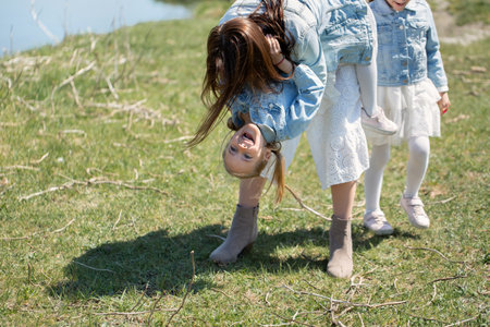 Mother and daughter have fun near a reservoir in the villageの写真素材