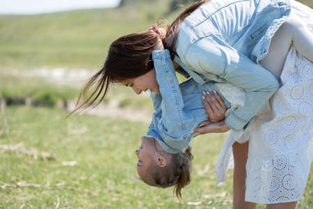 Mother and daughter have fun near a reservoir in the villageの写真素材