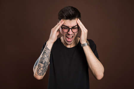 man screaming mouth open, hold head hand, isolated background, concept face emotion.の写真素材