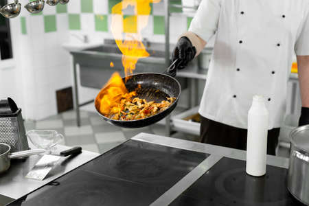 Modern kitchen. Cooks prepare meals on the stove in the kitchen of the restaurant or hotel. The fire in the kitchen.の写真素材