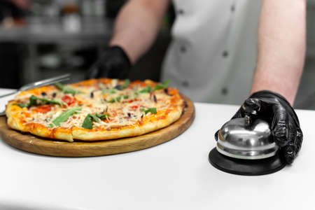 Cook with a ready-made dish with pizzaの写真素材