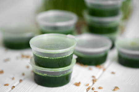 Frosted jars with wetgrass on the background of wheat germ
