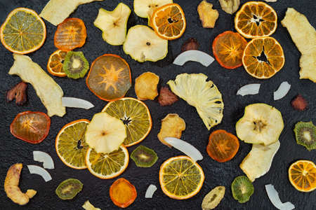 Organic Healthy Assorted Dried Fruit Close-up. Snacks from fraps: apple, pear, orange, banana, persimmon, coconut pineapple strawberry.の写真素材