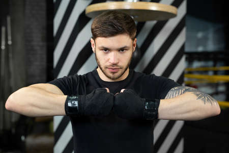 Close-up of the boxers hand is ready to fight. The concept. Strong hands and clenched fists.