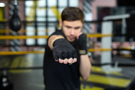 Close-up of the boxers hand is ready to fight. The concept. Strong hands and clenched fists.の写真素材