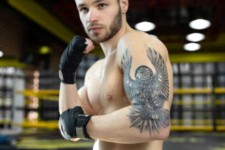 Portrait of a boxer with bandages on his hands. The concept of sport