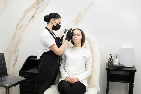 Permanent eyebrow makeup procedure. Eyebrow tattooing, the process in the salon