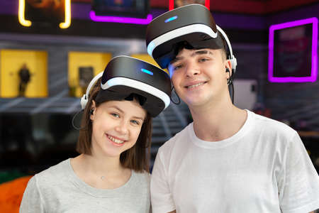 Portrait of teenage friends, a boy and a girl in virtual reality glasses