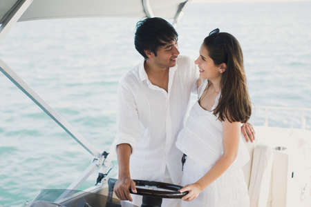 Young couple navigating on a yacht in Indian ocean.の写真素材