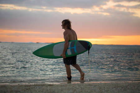 Silhouette paddle board surfer on the sunset background.の写真素材