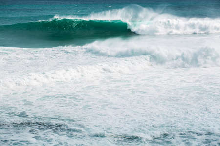 view from the beach to a tropical island and some granite rocks in the seaの写真素材
