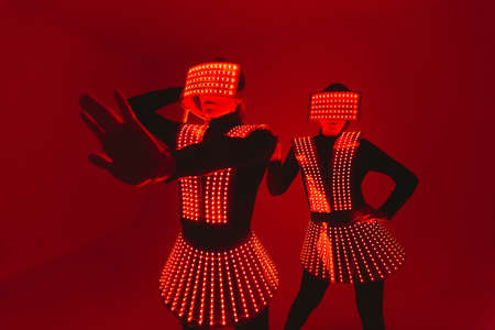 Two disco dancers move in UV costumes