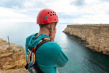 Extreme athlete is afraid of jumping from a great height. Rope jumping.の写真素材