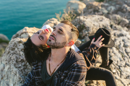 Portrait of a man and a woman in love on a cliff overlooking the sea.の写真素材