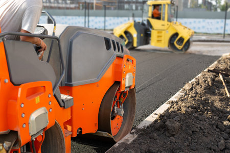 Road construction, asphalt concrete roller presses hot asphalt. A device for laying asphalt.の写真素材