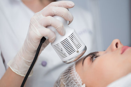 Cosmetology. Beautiful Woman Receiving Facial Skin Ultrasound Cavitation.の写真素材