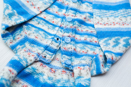 Knitted childrens sweater on a white background.