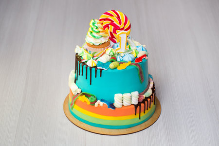 childrens festive colorful cake with sweets.