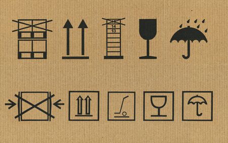 set of black packing symbols on cardboardの写真素材