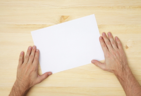 human hand holds a blank paperの写真素材
