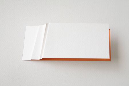 white paper card on red backgroundの写真素材