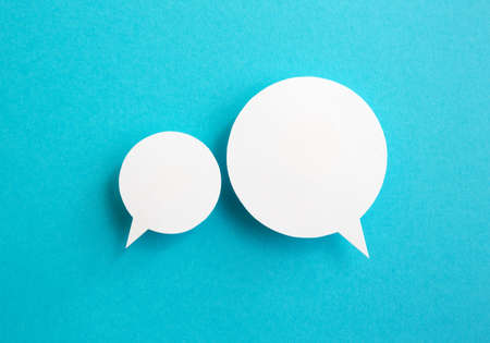 paper speech bubble on blue backgroundの写真素材