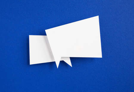 paper speech bubble on blue backgroundの写真素材